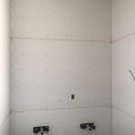 Inside bathroom area. White tiles.